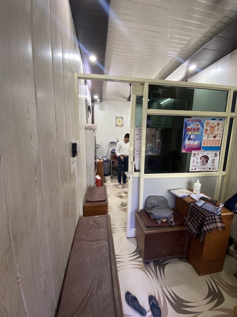 Long interior view of Panwar Dental Clinic with treatment room and reception visible