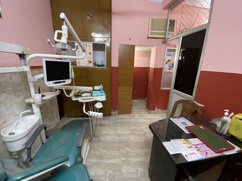 Wide red treatment room view with dental care in progress at Panwar Dental Clinic
